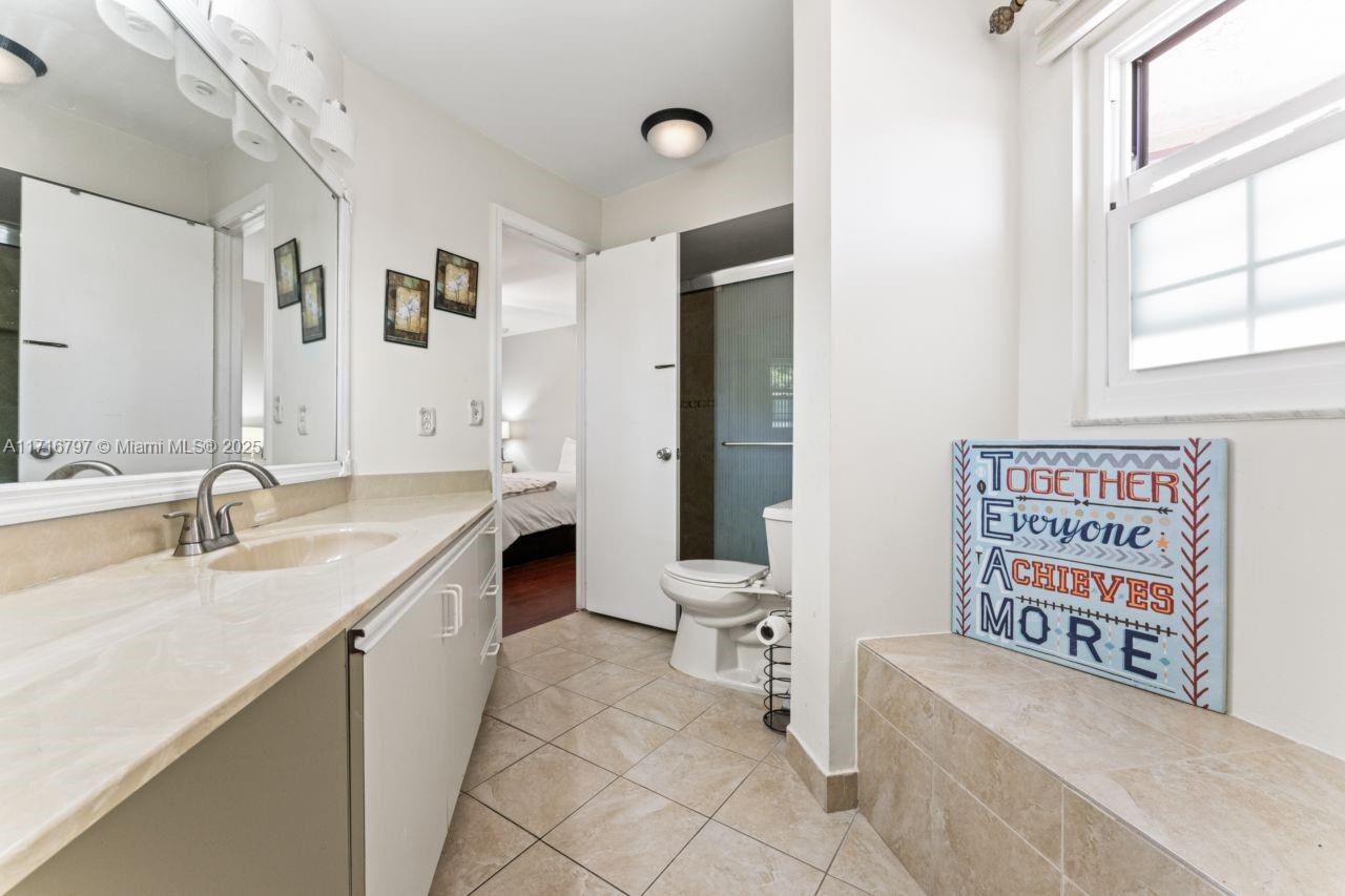20929 Boca Ridge Drive West Boca Raton, FL 33428 - Photo 30 of 47 a bathroom with a granite countertop sink a toilet and a bathtub