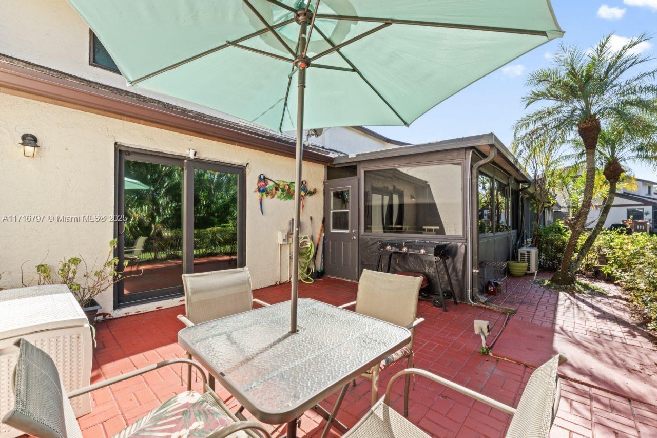 20929 Boca Ridge Drive West Boca Raton, FL 33428 - Photo 38 of 47 a outdoor space with patio the couches and a table with potted plants