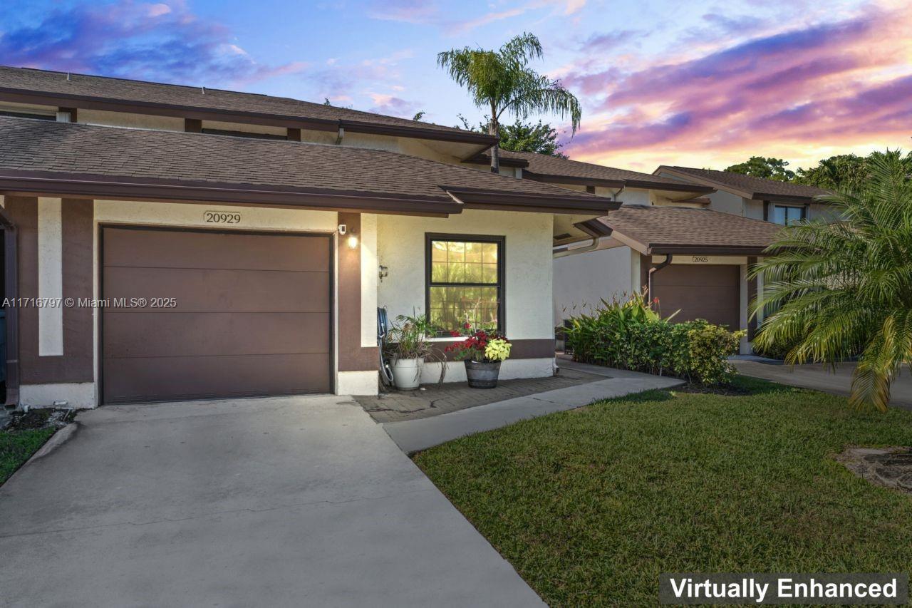 20929 Boca Ridge Drive West Boca Raton, FL 33428 - Photo 5 of 47 a front view of a house with garden