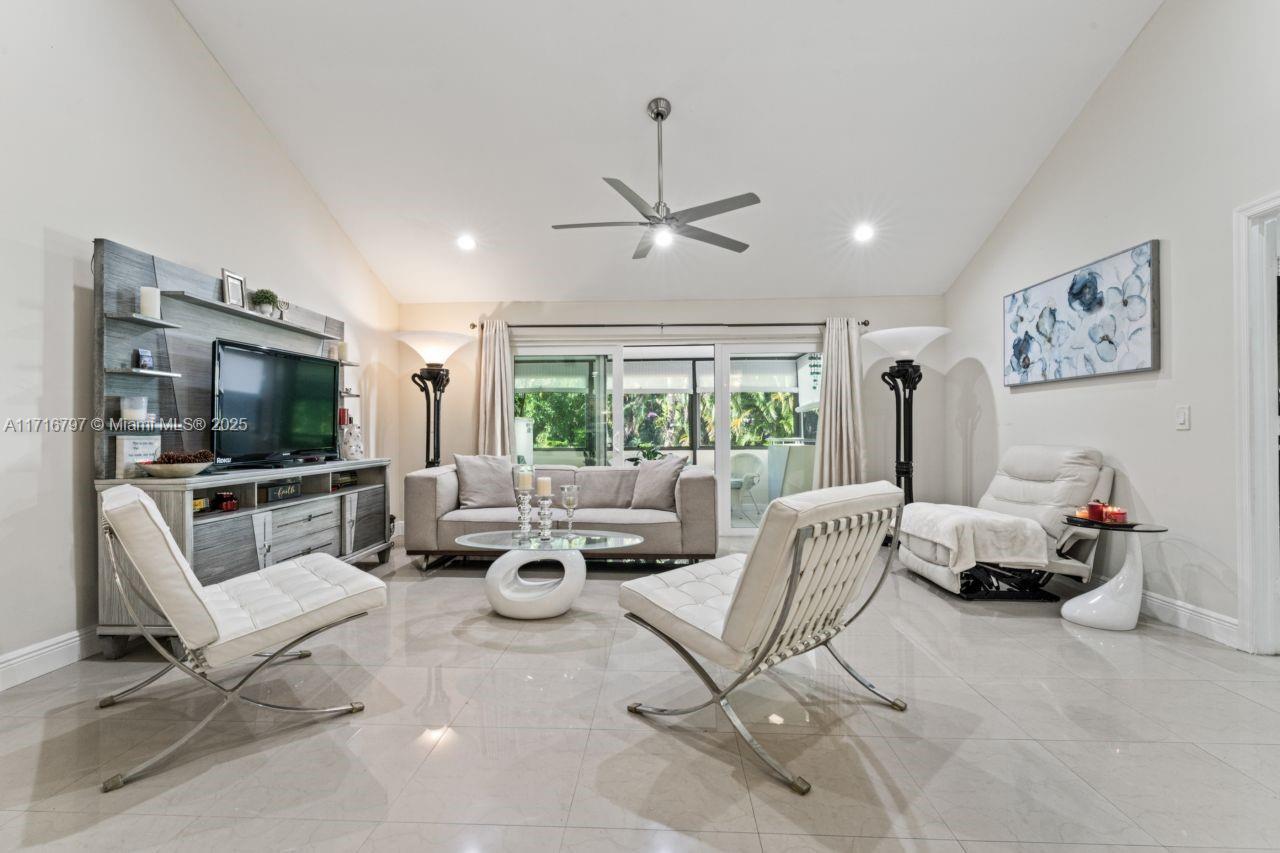 20929 Boca Ridge Drive West Boca Raton, FL 33428 - Photo 6 of 47 a living room with furniture and a flat screen tv