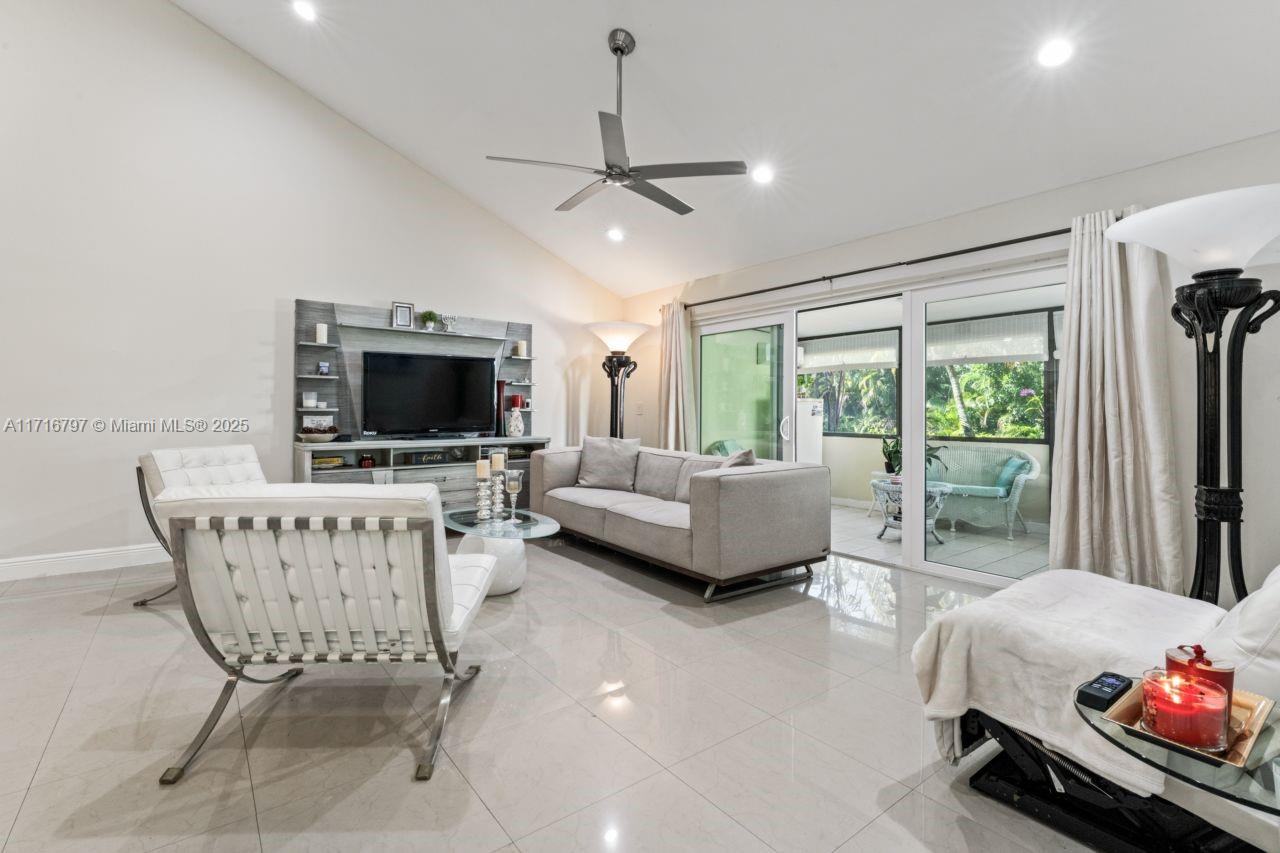 20929 Boca Ridge Drive West Boca Raton, FL 33428 - Photo 7 of 47 a living room with furniture and a flat screen tv