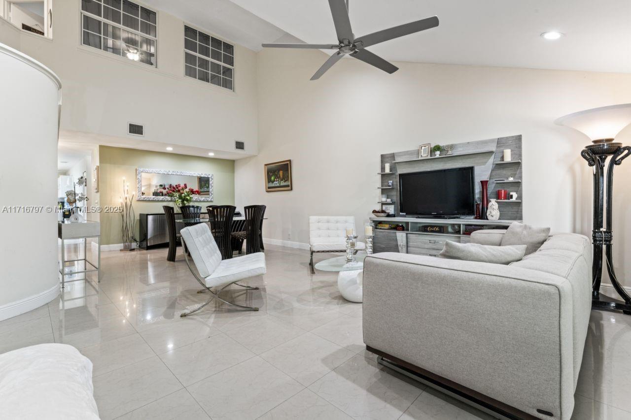 20929 Boca Ridge Drive West Boca Raton, FL 33428 - Photo 8 of 47 a living room with furniture and a flat screen tv