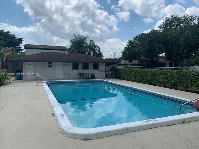 a view of a swimming pool with a yard