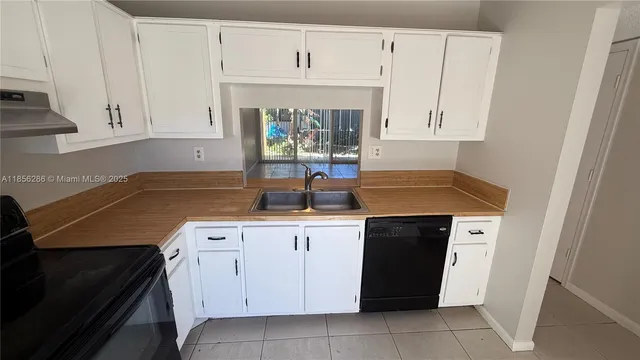 a kitchen with cabinets and white appliances