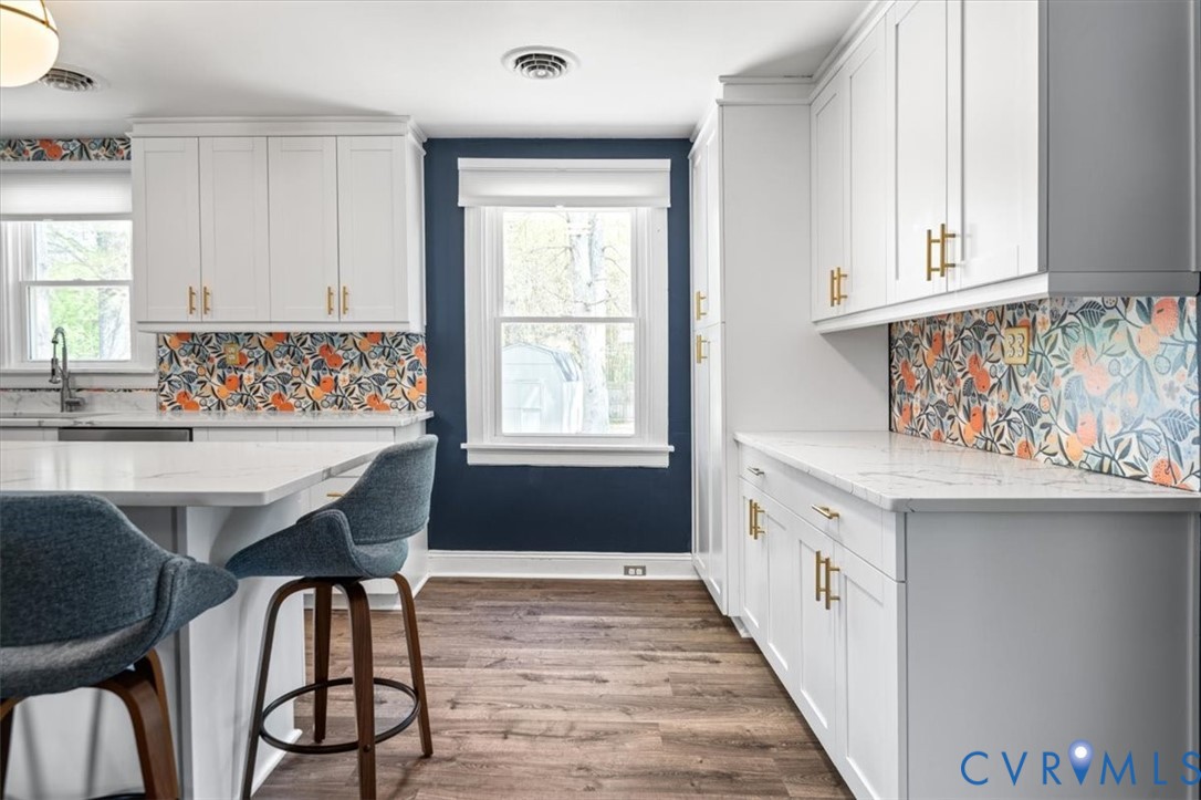 6805 Hermitage Road Henrico, VA 23228 - Photo 12 of 46 a kitchen with stainless steel appliances granite countertop a table chairs sink and cabinets