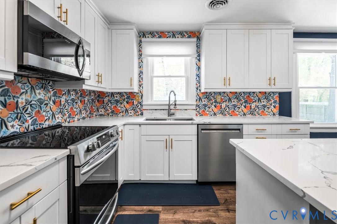 6805 Hermitage Road Henrico, VA 23228 - Photo 13 of 46 a kitchen with stainless steel appliances a sink stove and cabinets