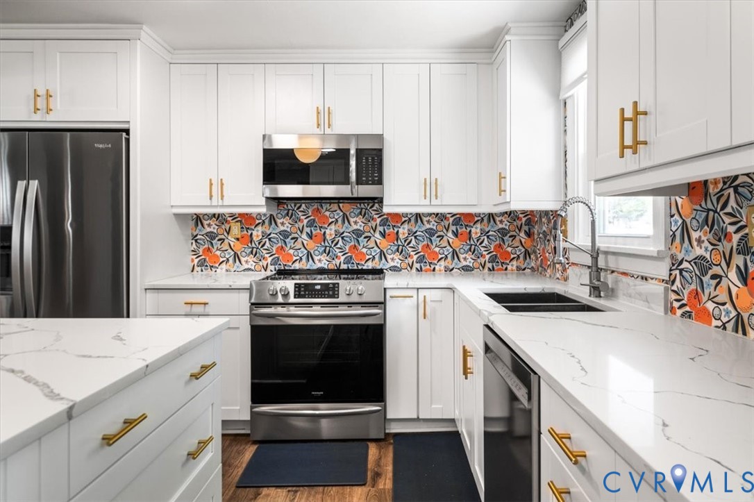 6805 Hermitage Road Henrico, VA 23228 - Photo 16 of 46 a kitchen with white cabinets sink and stainless steel appliances