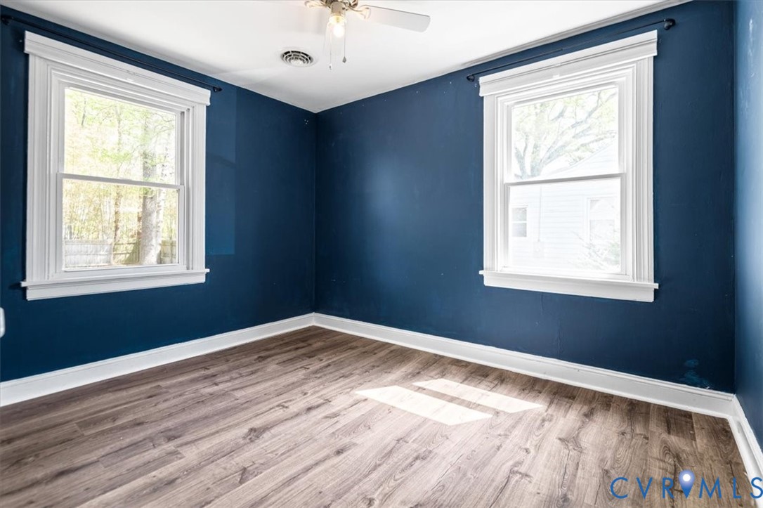 6805 Hermitage Road Henrico, VA 23228 - Photo 24 of 46 a view of an empty room with wooden floor and a window