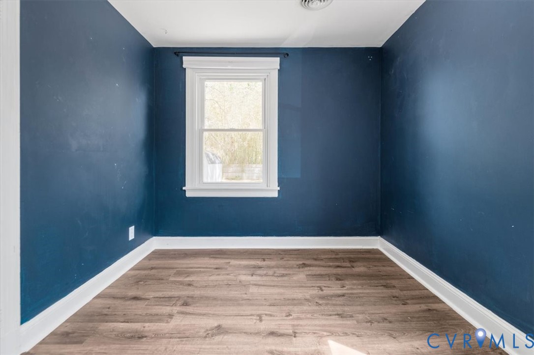 6805 Hermitage Road Henrico, VA 23228 - Photo 25 of 46 an empty room with wooden floor and windows