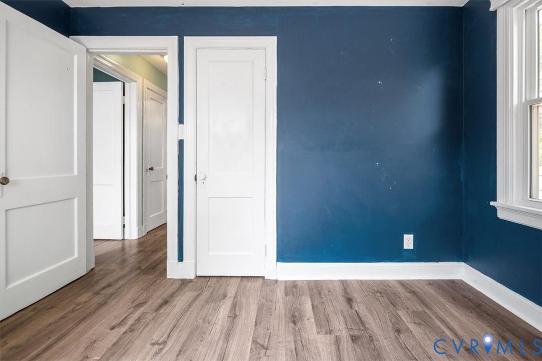 6805 Hermitage Road Henrico, VA 23228 - Photo 26 of 46 a view of an empty room with wooden floor and a window