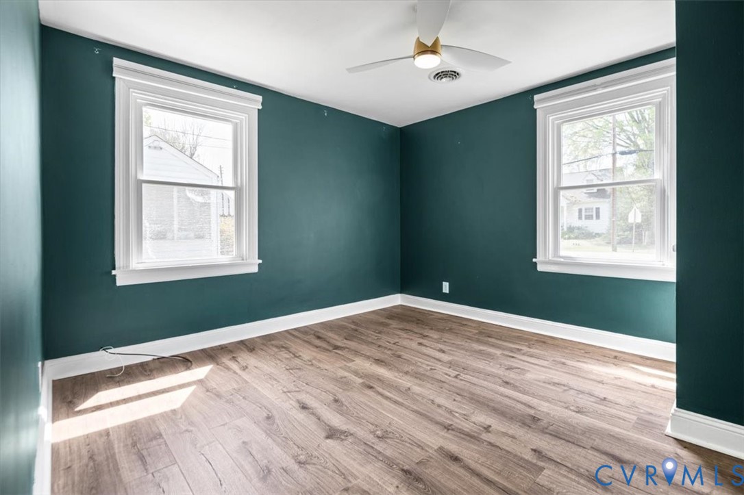 6805 Hermitage Road Henrico, VA 23228 - Photo 27 of 46 a view of an empty room with wooden floor and a window