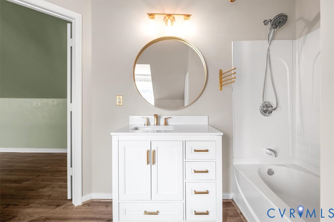 6805 Hermitage Road Henrico, VA 23228 - Photo 37 of 46 a bathroom with a sink a mirror and a bathtub