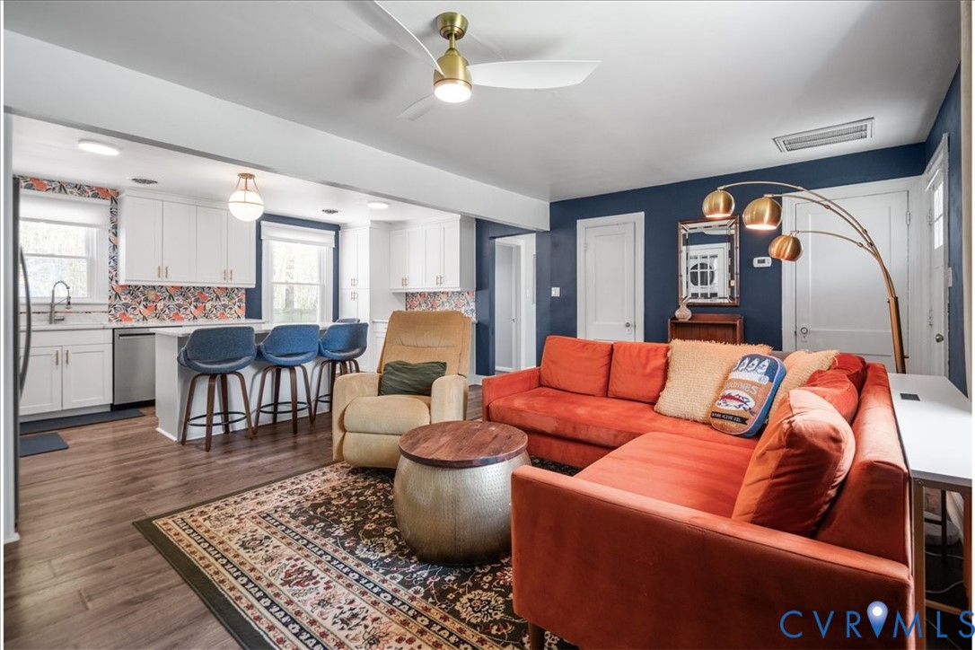 6805 Hermitage Road Henrico, VA 23228 - Photo 8 of 46 a living room with furniture a rug and a chandelier