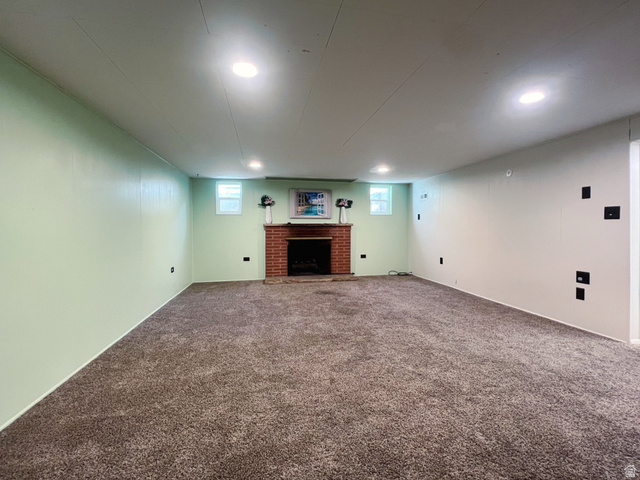 3138 Jean Street Magna, UT 84044 - Photo 21 of 26 Spacious room featuring broadloom carpet, recessed lighting, and a brick fireplace