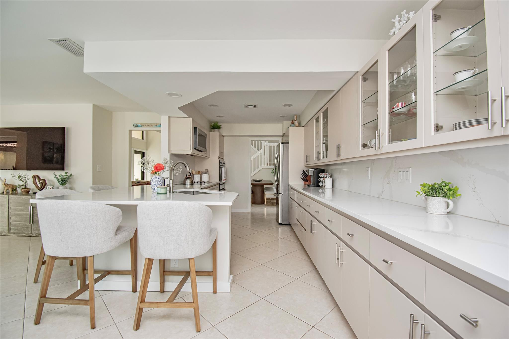 21694 Town Pl Drive Boca Raton, FL 33433 - Photo 22 of 55 a kitchen with cabinets and chairs