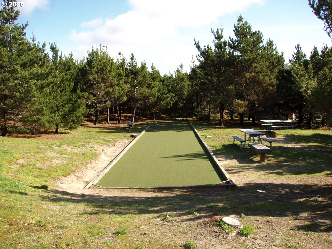 Promontory Lane, Unit 169 Tillamook, OR 97141 - Photo 16 of 22 a view of a swimming pool with a yard and large trees