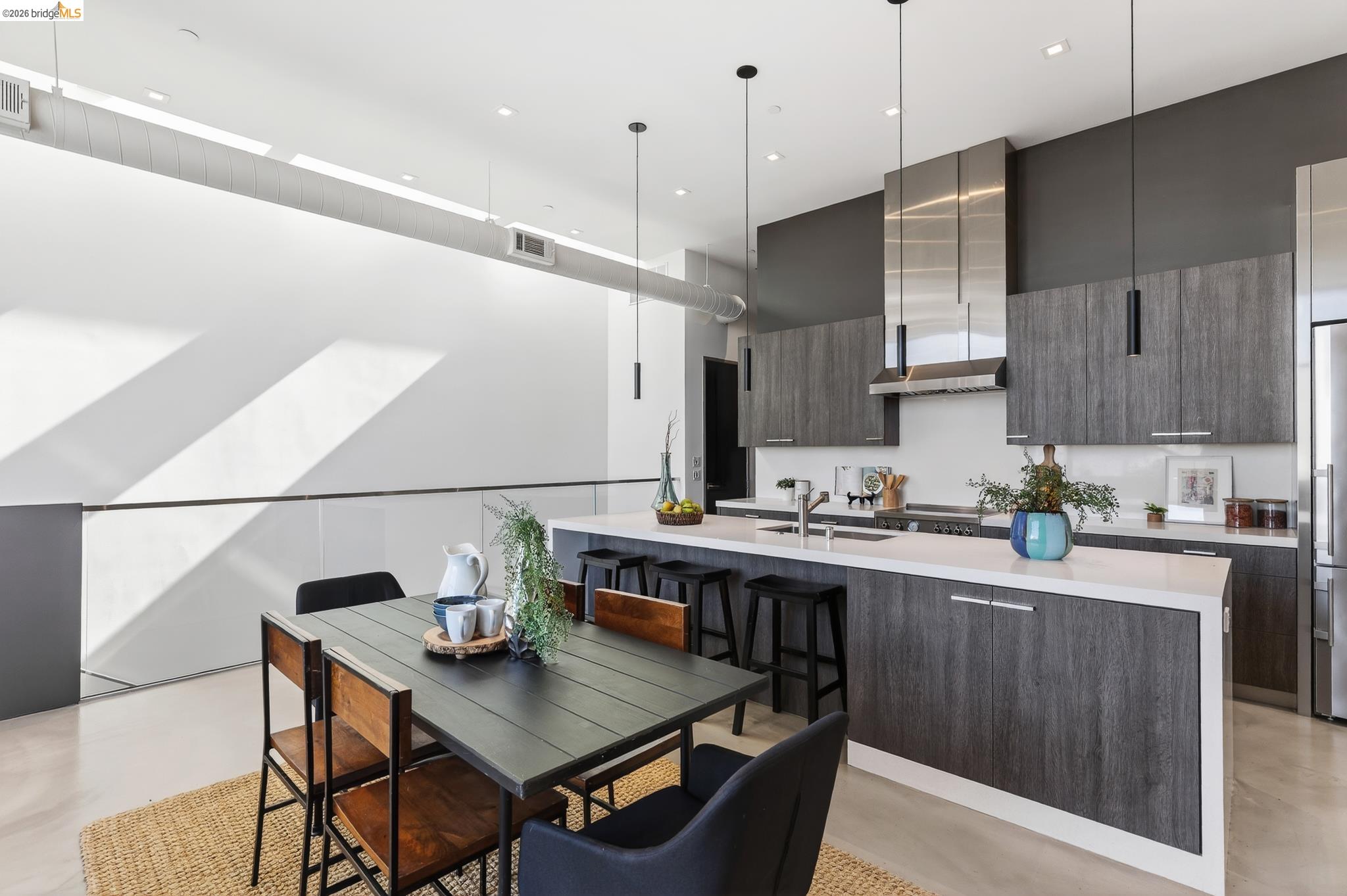 811 Folger Avenue Berkeley, CA 94710 - Photo 11 of 41 a kitchen with stainless steel appliances kitchen island granite countertop a sink a stove a refrigerator and a dining table with wooden floor