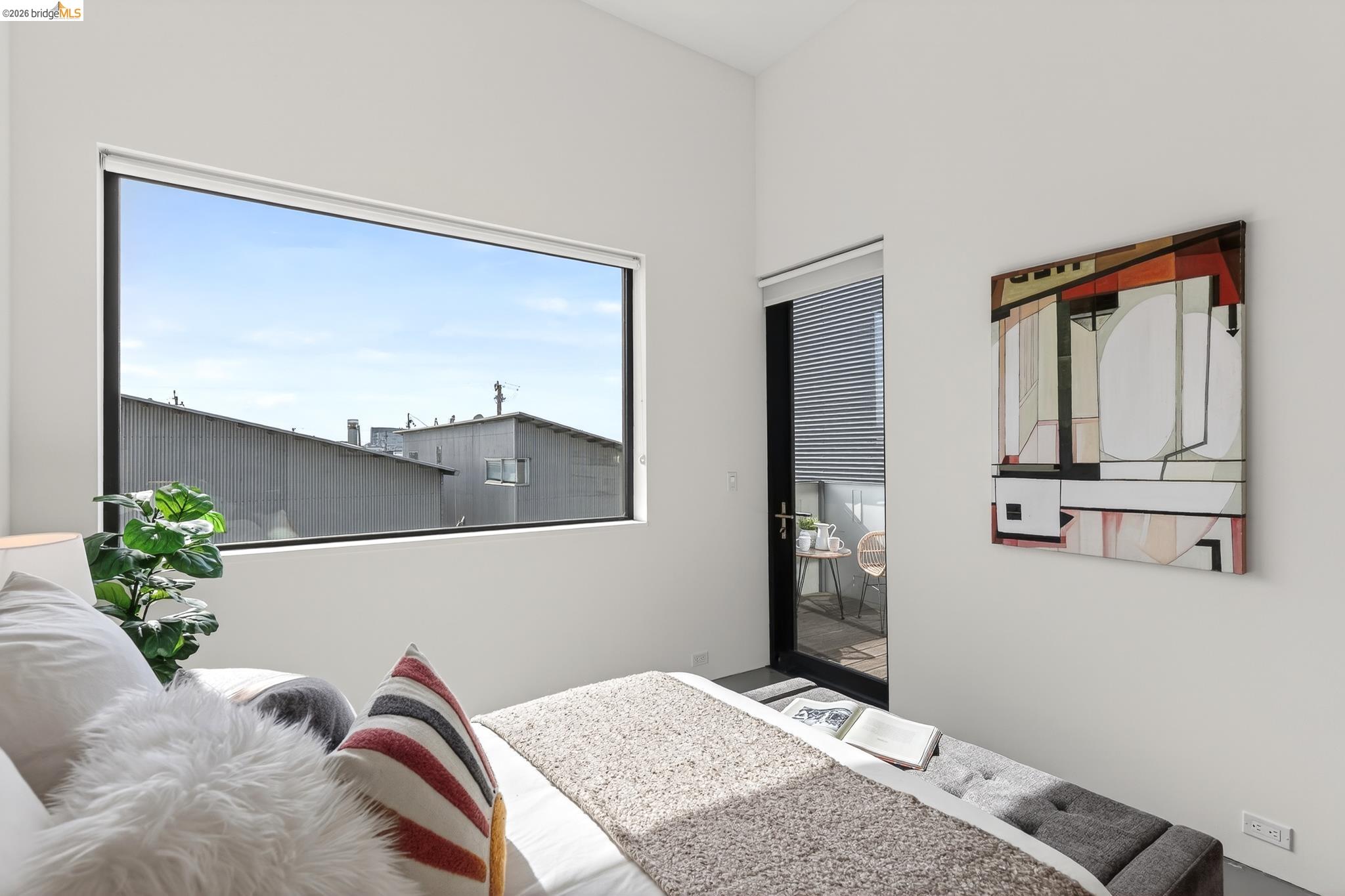 811 Folger Avenue Berkeley, CA 94710 - Photo 16 of 41 a bedroom with a bed and a potted plant
