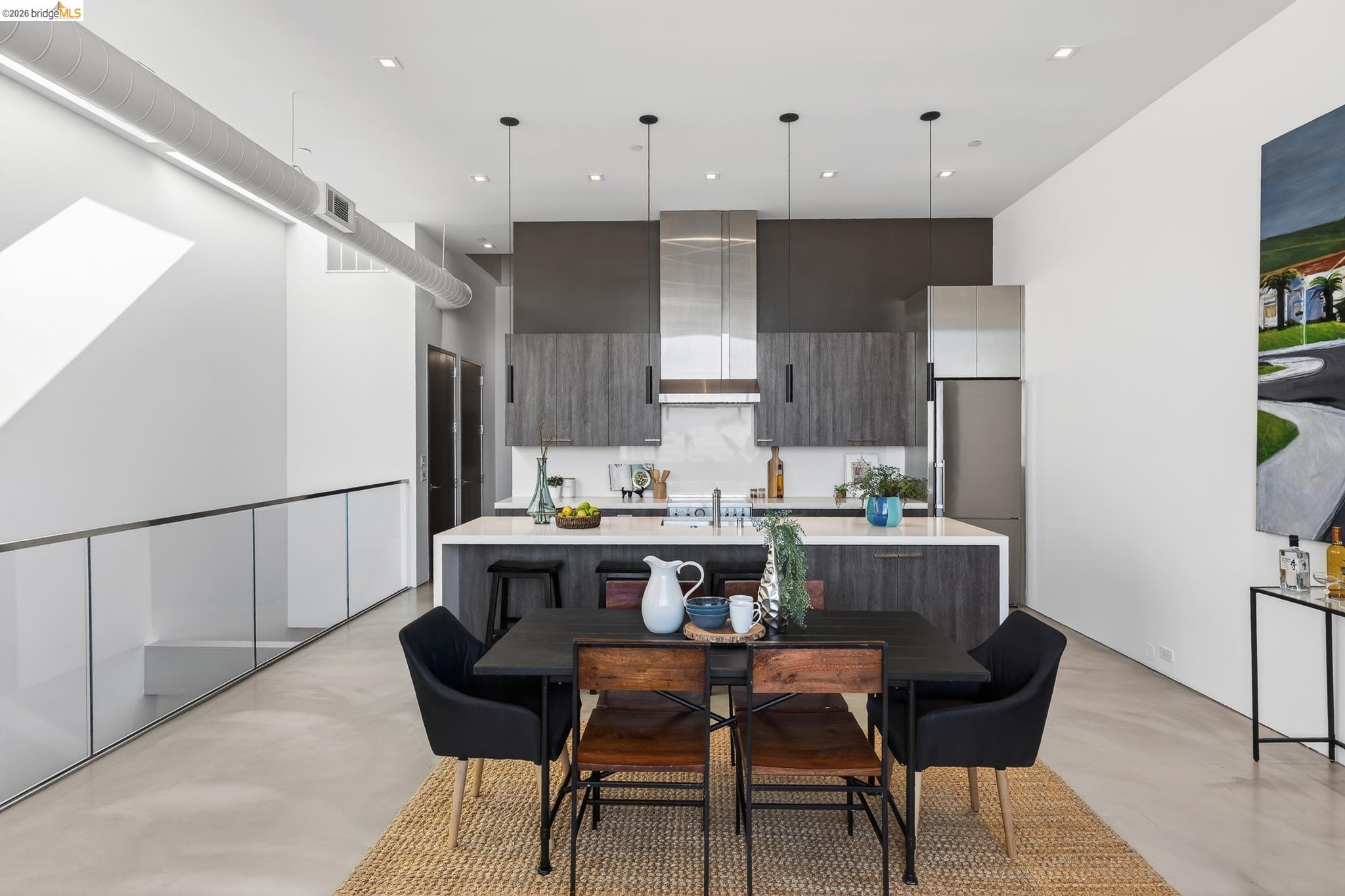 811 Folger Avenue Berkeley, CA 94710 - Photo 8 of 41 a kitchen with a table chairs refrigerator and microwave