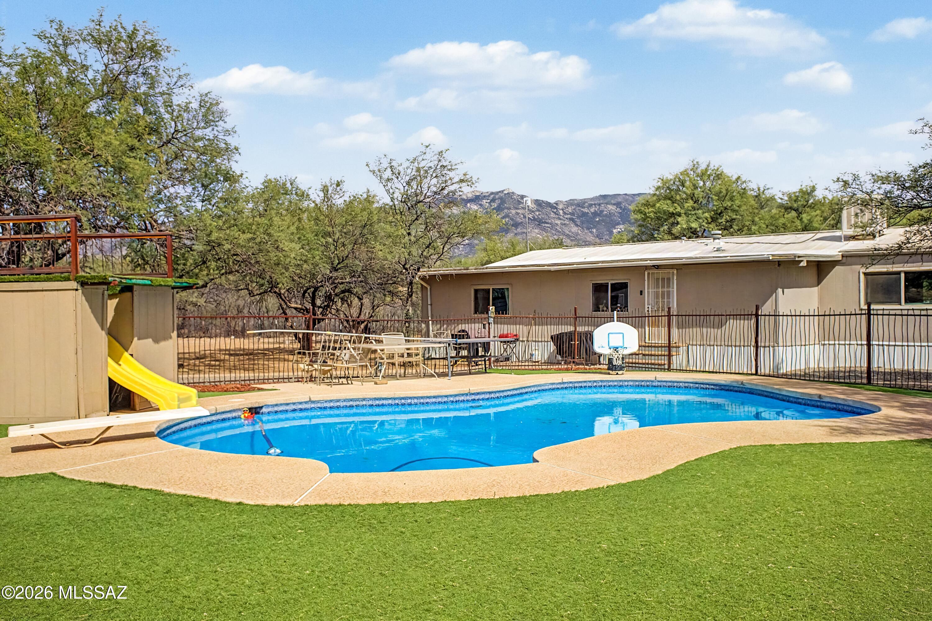 4231 East Pinal Street Tucson, AZ 85739 - Photo 36 of 36 a view of house with swimming pool yard fire pit and outdoor seating