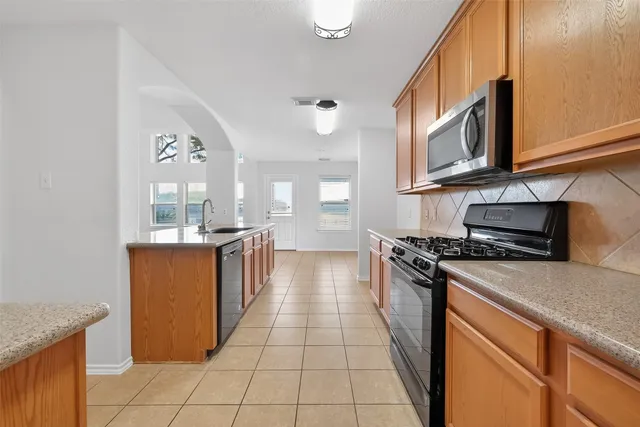 a kitchen with stainless steel appliances granite countertop a stove and a sink