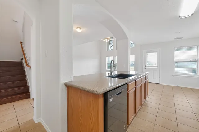 a kitchen with a sink a counter top space and cabinets