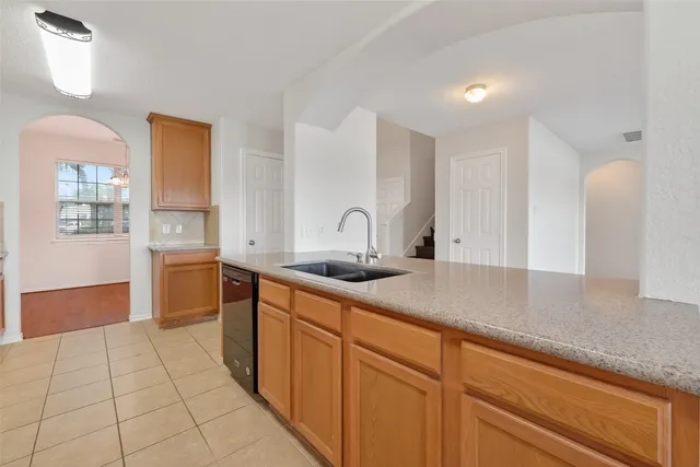 a kitchen with a sink and cabinets
