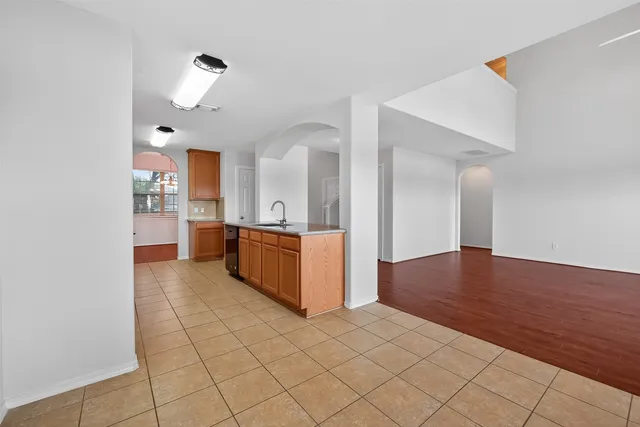 a large kitchen with cabinets and wooden floor