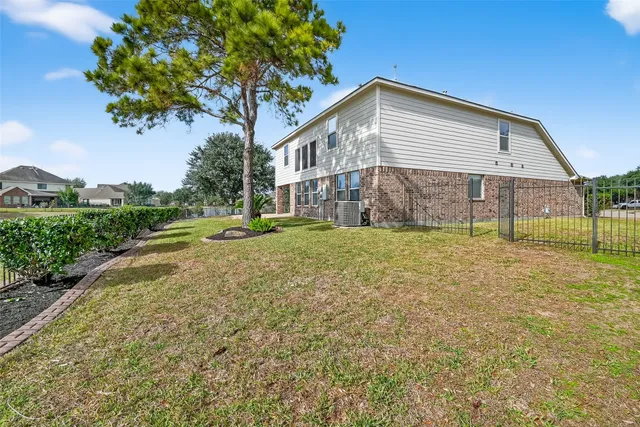 a view of a fountain in front of a house with a big yard