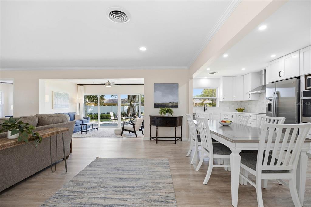 1218 Taylor Avenue Dunedin, FL 34698 - Photo 2 of 53 a kitchen with stainless steel appliances granite countertop a dining table chairs stove a refrigerator and cabinets