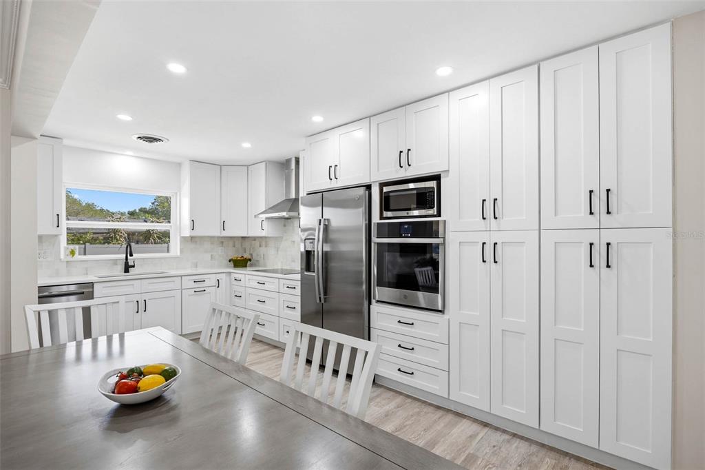 1218 Taylor Avenue Dunedin, FL 34698 - Photo 36 of 53 a kitchen with stainless steel appliances a refrigerator and cabinets