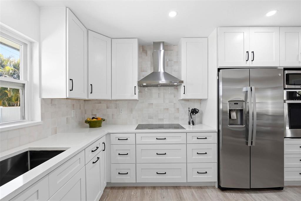 1218 Taylor Avenue Dunedin, FL 34698 - Photo 4 of 53 a kitchen with stainless steel appliances a refrigerator sink and cabinets
