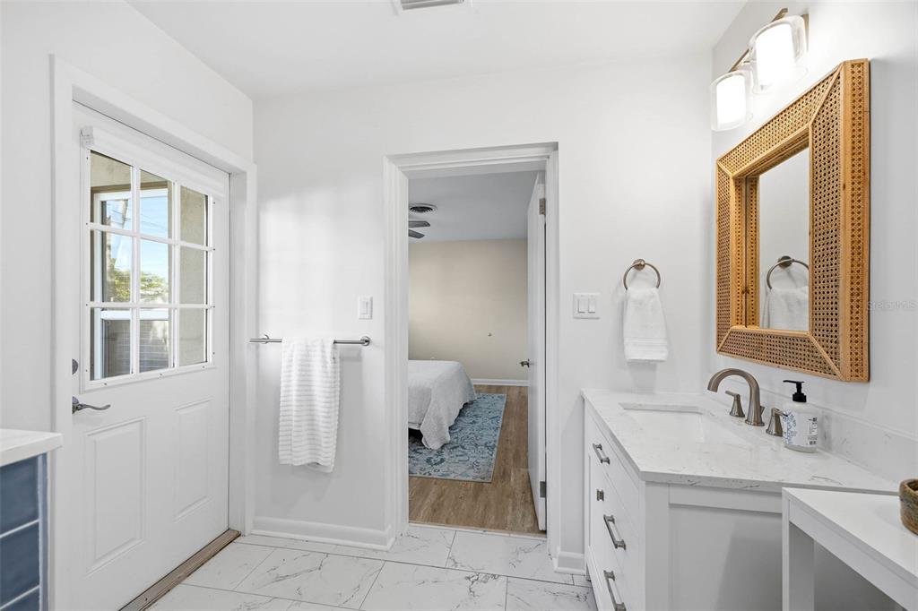 1218 Taylor Avenue Dunedin, FL 34698 - Photo 46 of 53 a bathroom with a granite countertop sink and a mirror