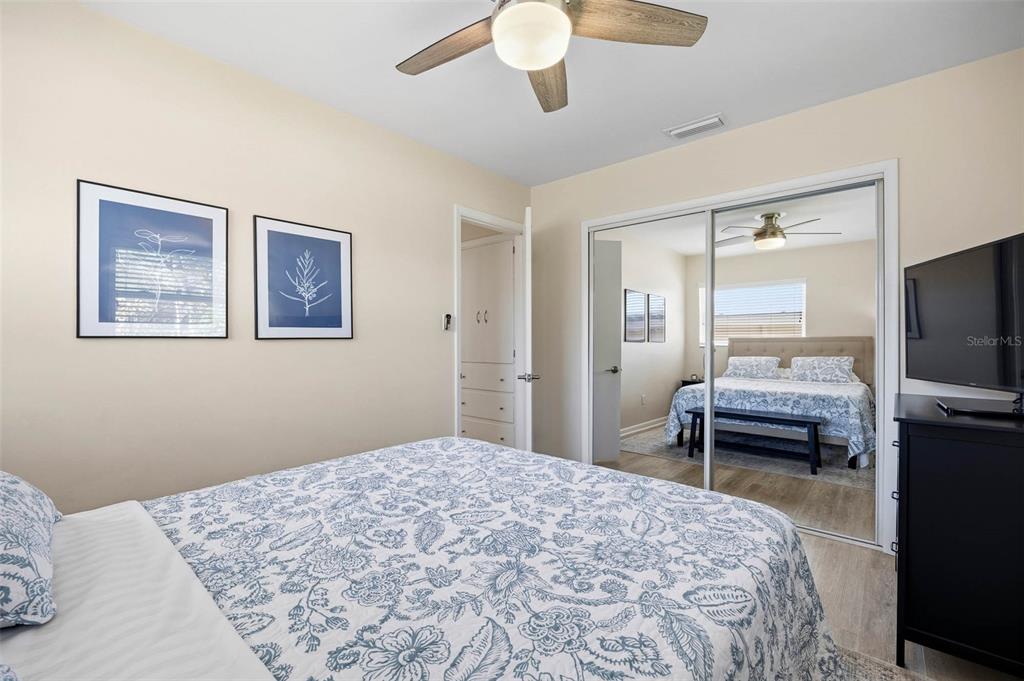 1218 Taylor Avenue Dunedin, FL 34698 - Photo 47 of 53 a bedroom with a bed and a chandelier