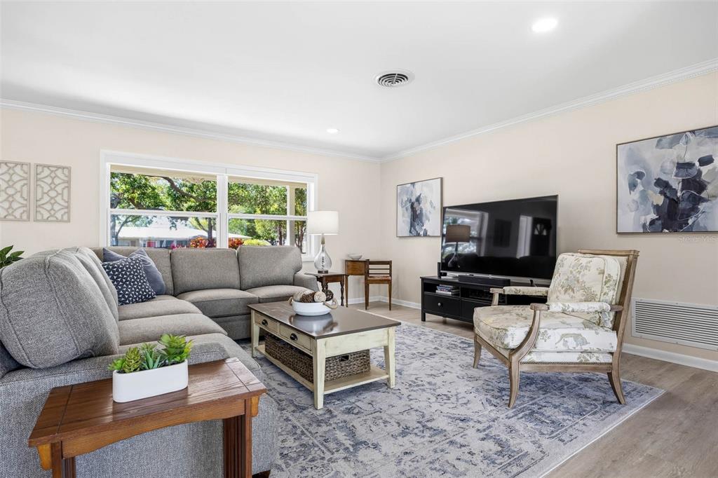 1218 Taylor Avenue Dunedin, FL 34698 - Photo 7 of 53 a living room with furniture a large window and a flat screen tv