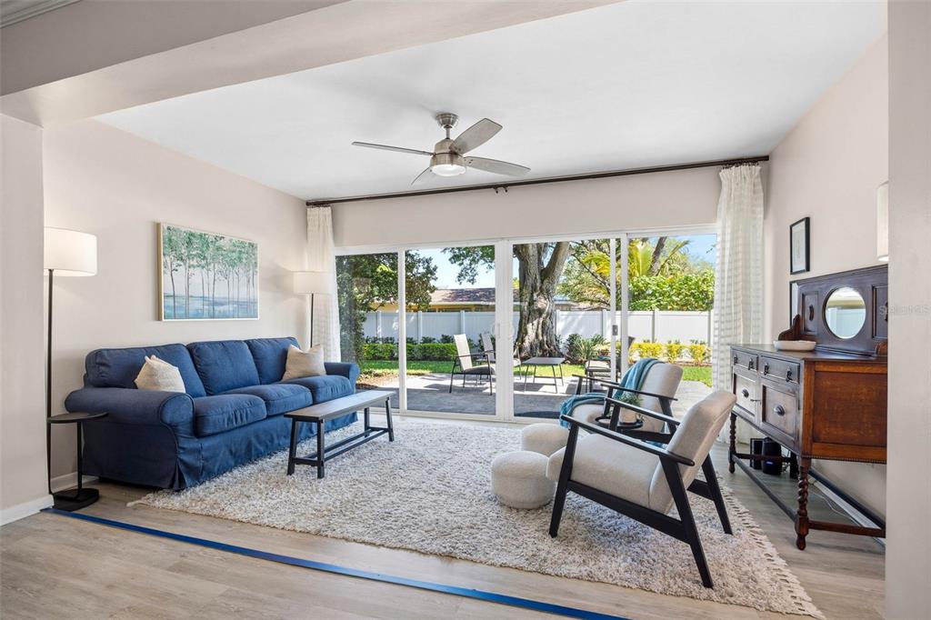 1218 Taylor Avenue Dunedin, FL 34698 - Photo 8 of 53 a living room with furniture a large window and a table