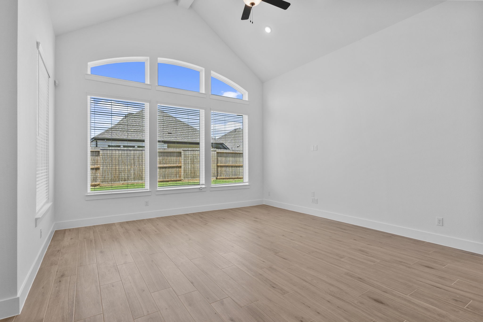 2910 Peach Vly Road Fulshear, TX 77423 - Photo 21 of 35 a view of an empty room with wooden floor and windows