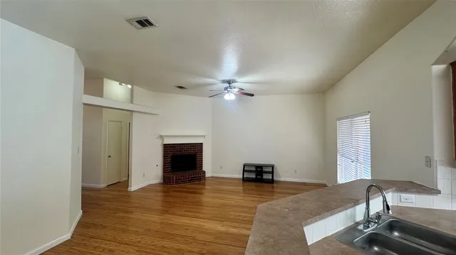 a kitchen with a sink appliances and cabinets