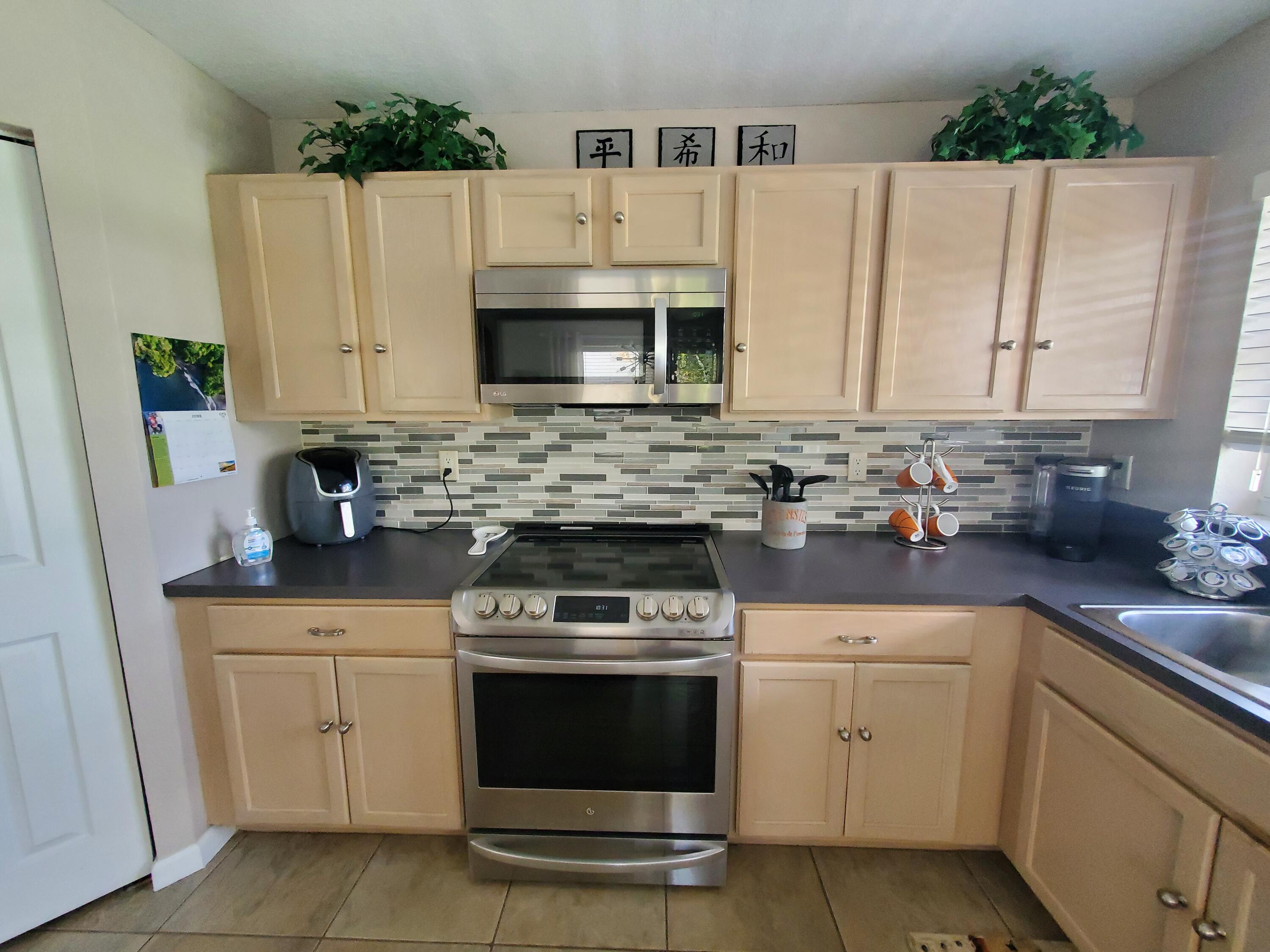 1037 Big Torch Street Riviera Beach, FL 33407 - Photo 14 of 38 updated backsplash and stove