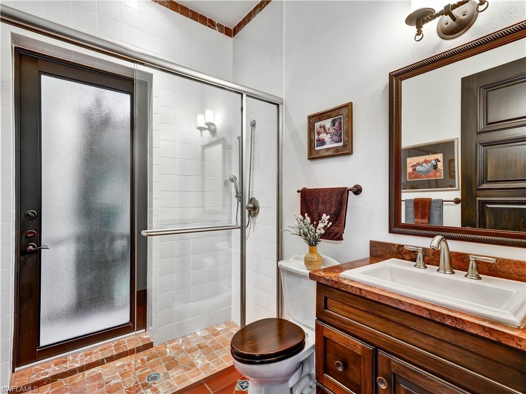 2535 Tarpon Road Naples, FL 34102 - Photo 22 of 50 Spacious room featuring multiple windows and glass doors, offering water frontage
