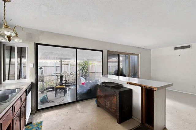 a view of a bedroom with furniture and windows