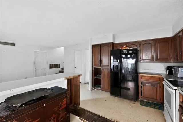 a kitchen with stainless steel appliances a refrigerator and a stove