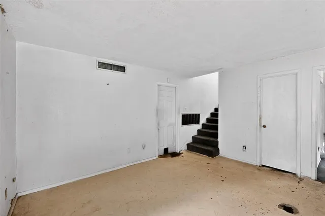 a view of an empty room with stairs