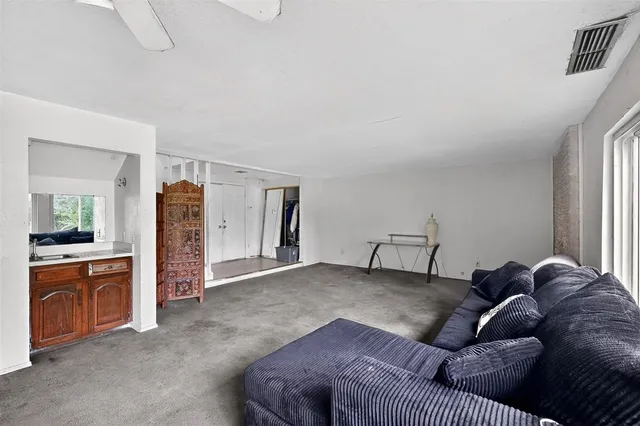 a living room with furniture and a kitchen