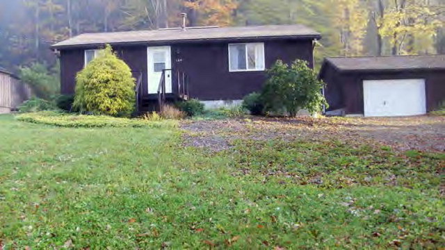 6129 Highway 666 Sheffield, PA 16347 - Photo 1 of 1 a front view of a house with garden