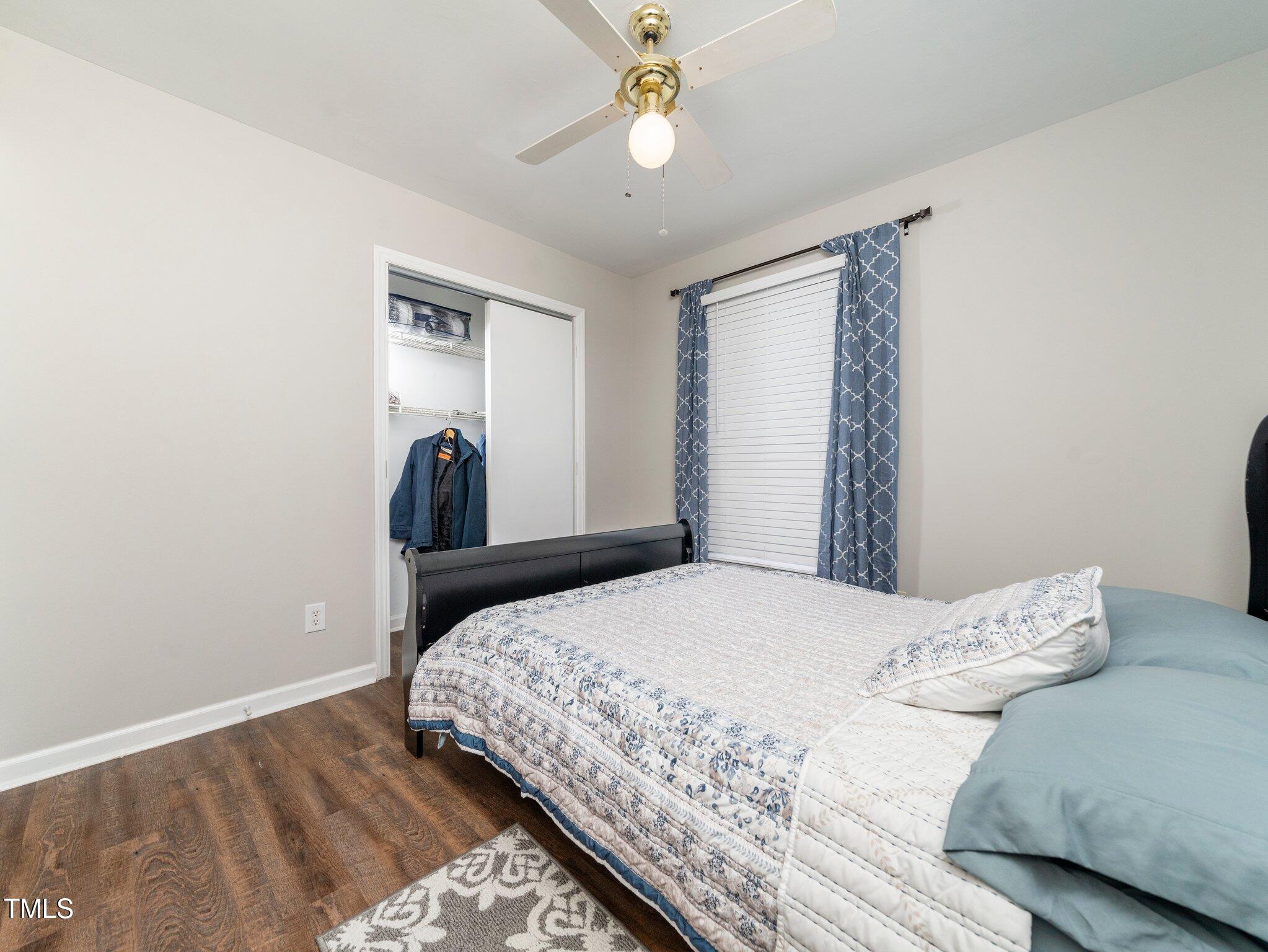 4216 Ferriday Court Raleigh, NC 27616 - Photo 22 of 29 a bedroom with a bed and a chandelier