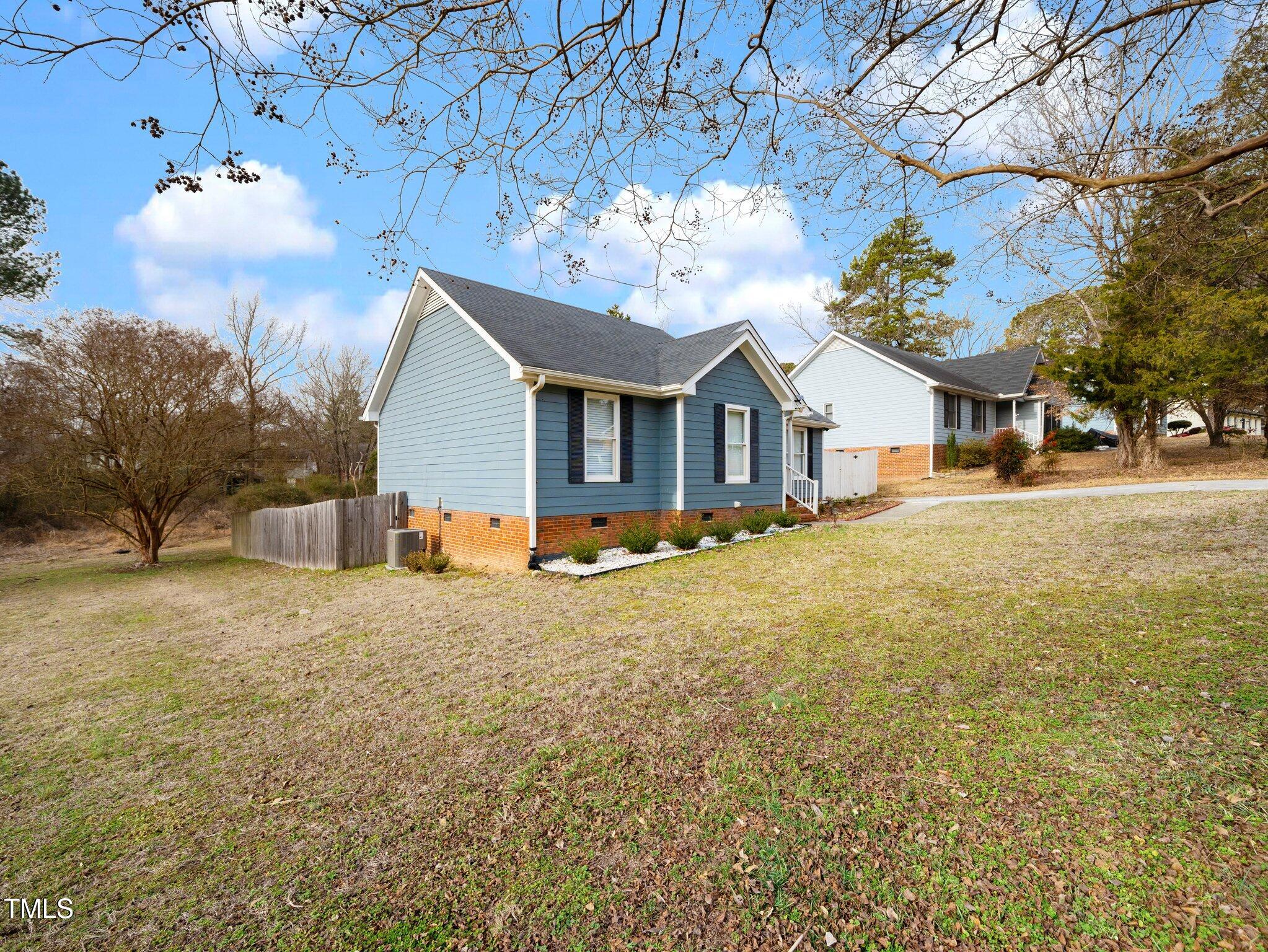 4216 Ferriday Court Raleigh, NC 27616 - Photo 4 of 29 a view of a house with a yard and large tree