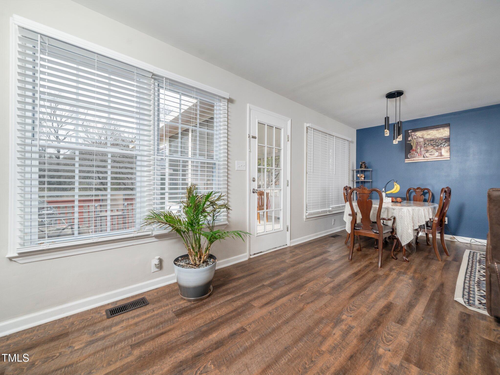 4216 Ferriday Court Raleigh, NC 27616 - Photo 6 of 29 a living room with furniture a potted plant and a large window