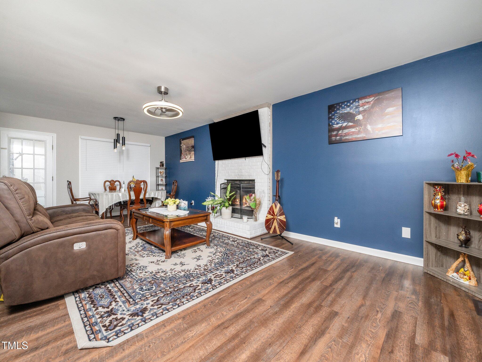 4216 Ferriday Court Raleigh, NC 27616 - Photo 7 of 29 a living room with furniture and a flat screen tv