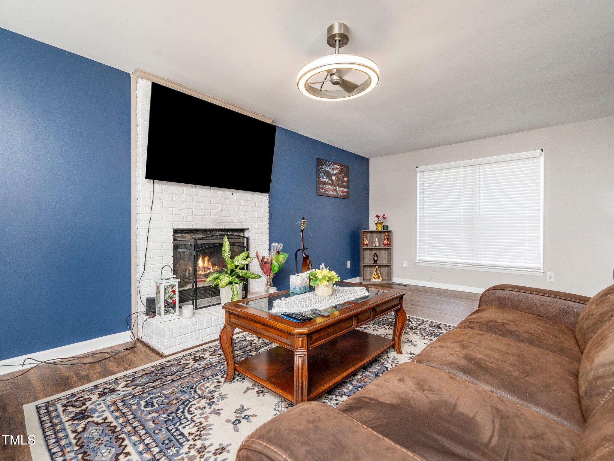 4216 Ferriday Court Raleigh, NC 27616 - Photo 10 of 29 a living room with furniture and a fireplace